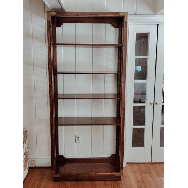 Asian style rosewood 5-tier shelving unit. Each side has beautiful fretwork with brass caps on each corner at the front....