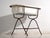 This antique bathtub in enamelled iron rests on a folding stand of bent iron tube. Originates from Central Europe, from...