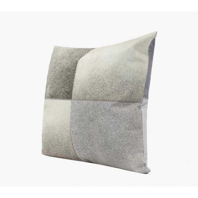 This square throw pillow is crafted from four pieces of high-quality leather in varying shades of gray, seamlessly...