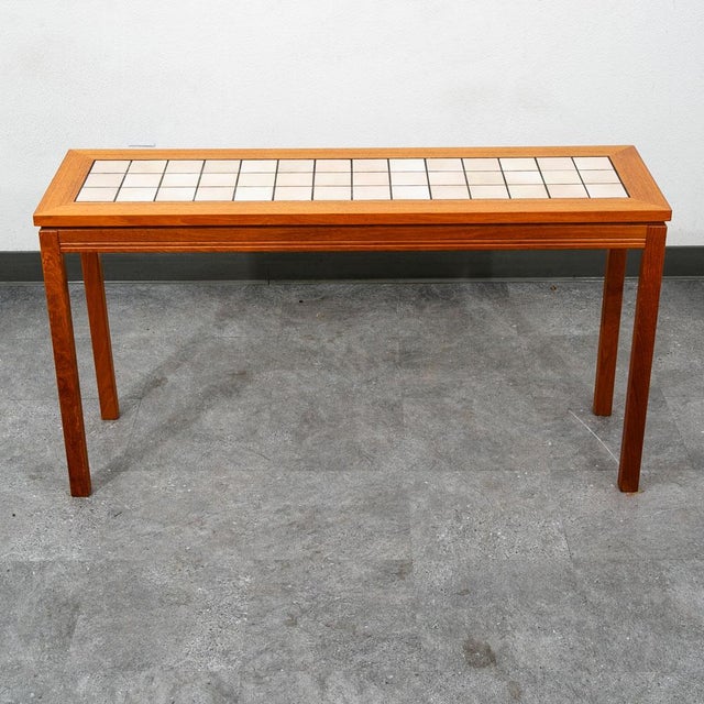 Functional and handsome rectangular console or entry / hallway table in teak and ceramic tile. The grain and wood looks...