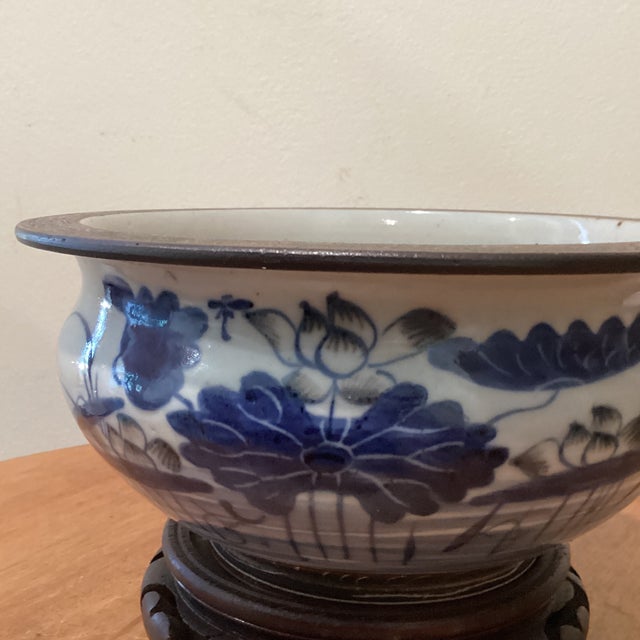 This collectable Qianlong Period blue and white glazed porcelain censer/bowl with a wood base is a rare and valuable...