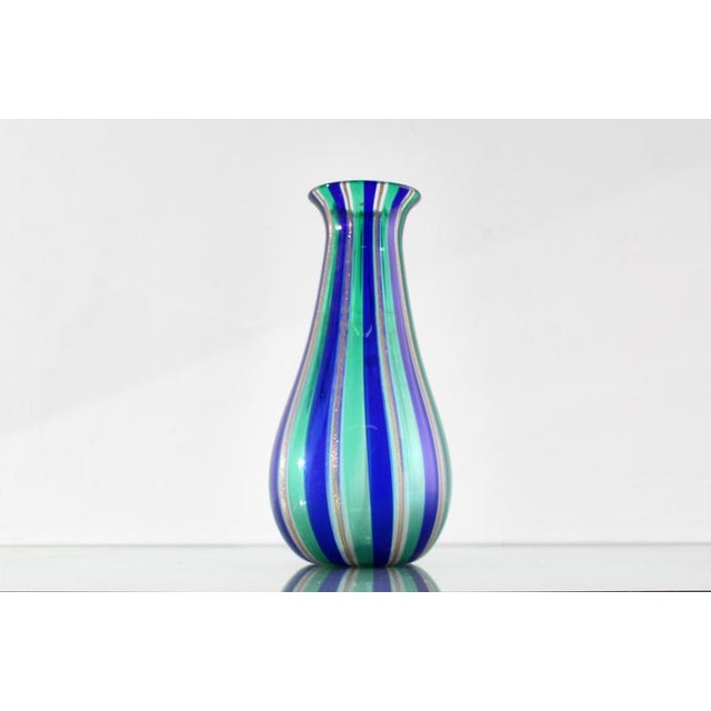 Delightful Murano blown glass vase with blue, green, and gold rods. In the style of Venini, Italian manufacture from the...