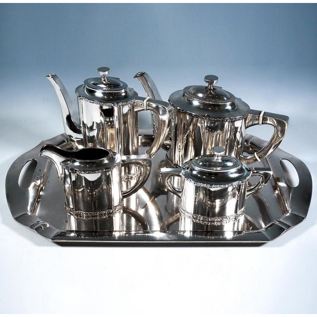 Elegant art nouveau silver centrepiece consisting of 5 pieces: coffee pot, teapot, sugar bowl, cream jug and tray. Vessels...