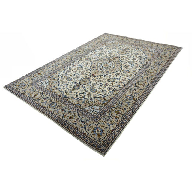 This beautiful hand-knotted Kashan oriental rug measuring 291 x 200 cm impresses with its classic beauty and elegant color...