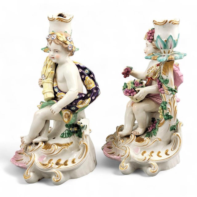 A pair of late Chelsea candlesticks produced between c.1775 and 1783 and representing the allegories of Summer and Autumn....