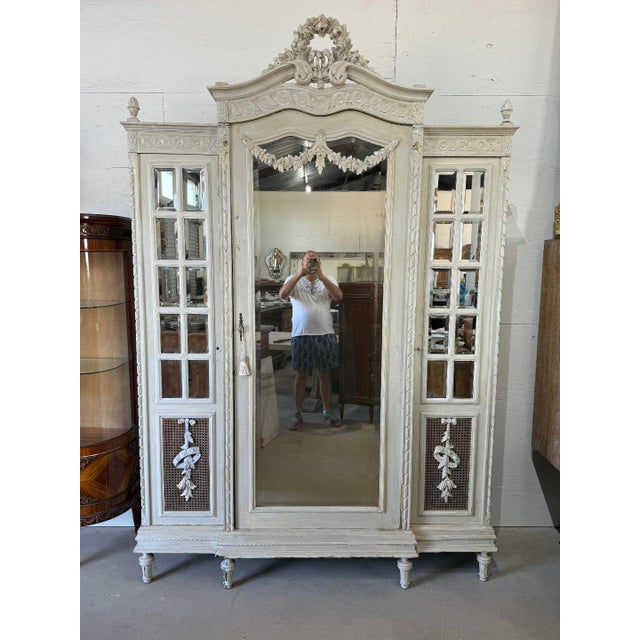 large French louis XVI 3 door bookcase or Armoire made of solid walnut. The wood has the original French paint from the...