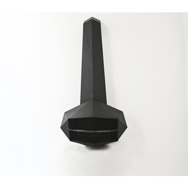 Wall-mounted fireplace in a diamond shape, made of patinated steel. Wear and tear due to time and age. This piece is...