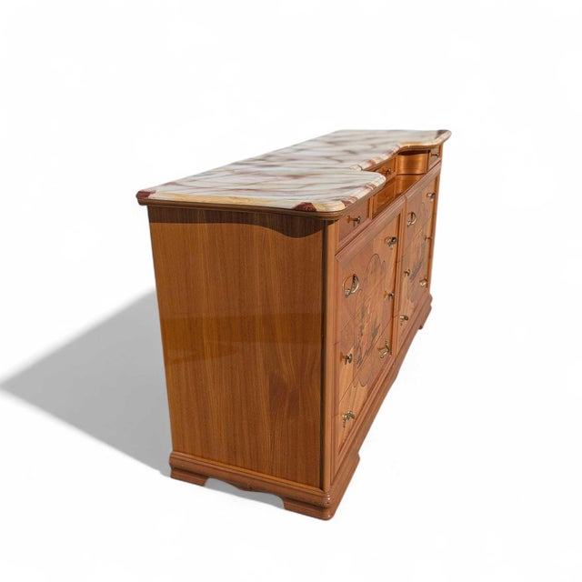 Large postmodern lacquer dresser with a faux marble top, neoclassical inlay-style panels, and brass-tone hardware. The...