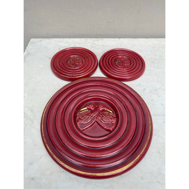 Set of 3 red Mid-Century Majolica pieces Vallauris unsigned , 2 Wine Coasters and 1 trivet with birds. Trivet / Diameter 8...