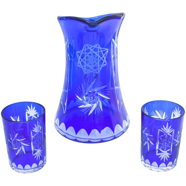 Elegant and heavy vintage handblown clear and blue crystal pitcher and matching glasses elegantly hand-cut with fine...