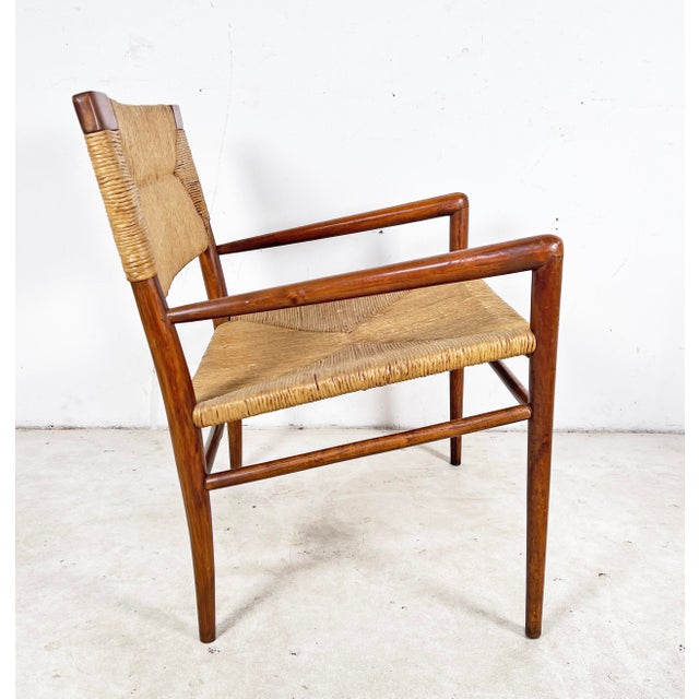 An original lounge chair in walnut with woven papercord seat and back, designed and produced in limited quantities by Mel...