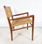 An original lounge chair in walnut with woven papercord seat and back, designed and produced in limited quantities by Mel...