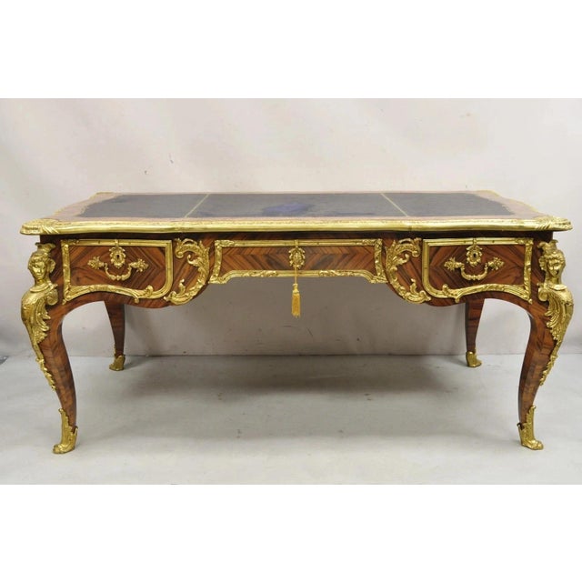 Vintage French Louis XV Style Figural Bronze Ormolu Leather Top Bureau Plat Writing Desk. Item features a large impressive...