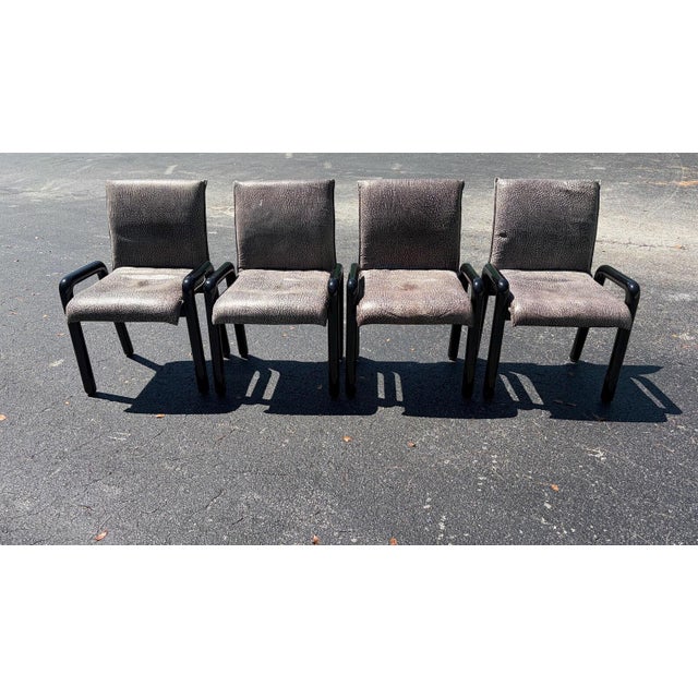 This is a set of 4 Dilos Dining chairs designed by Guido Faleschini for Pace. The chairs are done in black lacquered...