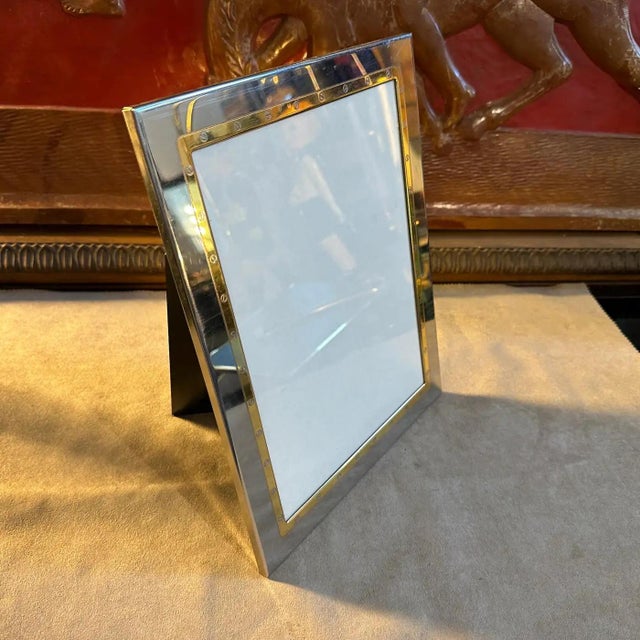 A rectangular picture frame designed and manufactured in Italy in the Eighties by MB Italy, the silver plated and gilde...