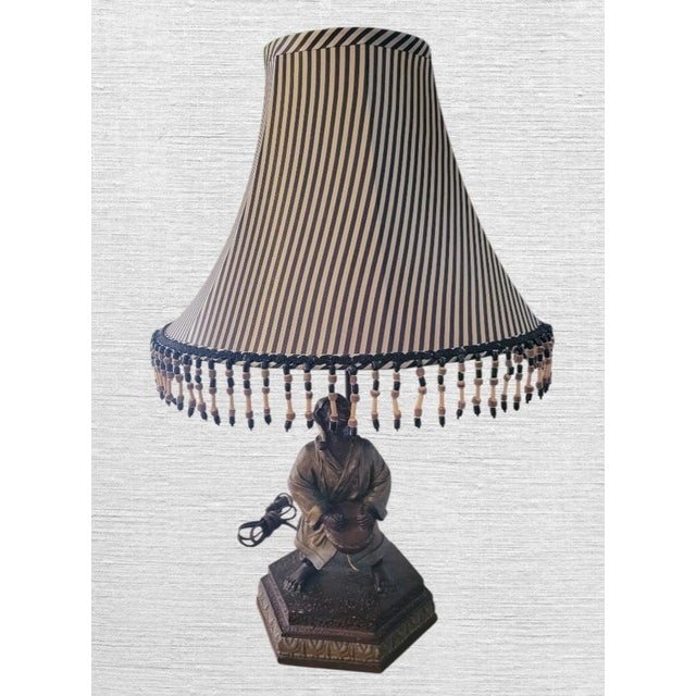 A whimsical and fun vintage monkey table lamp with striped shade. The lamp is extremely heavy, made of some sort of...