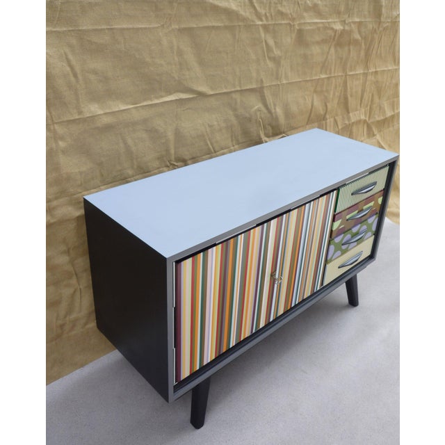 Laminate top in "mist" (light blue with a hint of mauve) Black PU lacquered frame Double lockable doors (key included)
