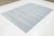 This beautiful rug features a contemporary gray design, handknotted with care, showcasing a charming light blue geometric...