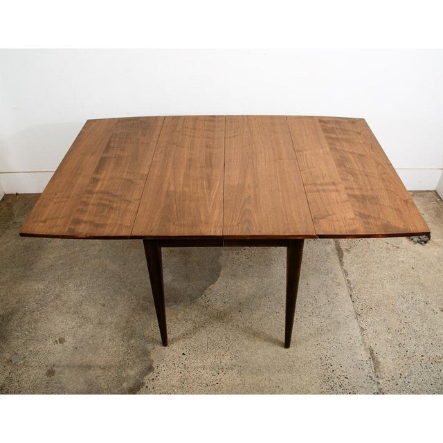 Fantastic and unique American walnut drop leaf dining table by Broyhill in a rectangular shape. Made Circa 1965. Table has...