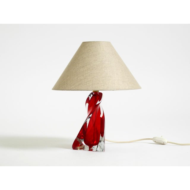 Beautiful, heavy Mid-Century Modern table lamp. The lamp base is made of turned solid crystal glass in red and clear....