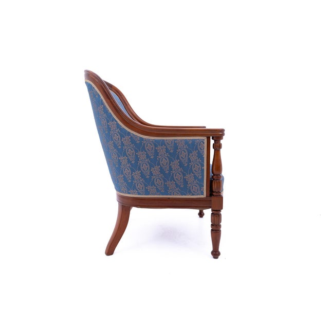 A pair of elegant french bergère armchairs dating to around 1880. The pieces feature a classic, rounded backrest that...