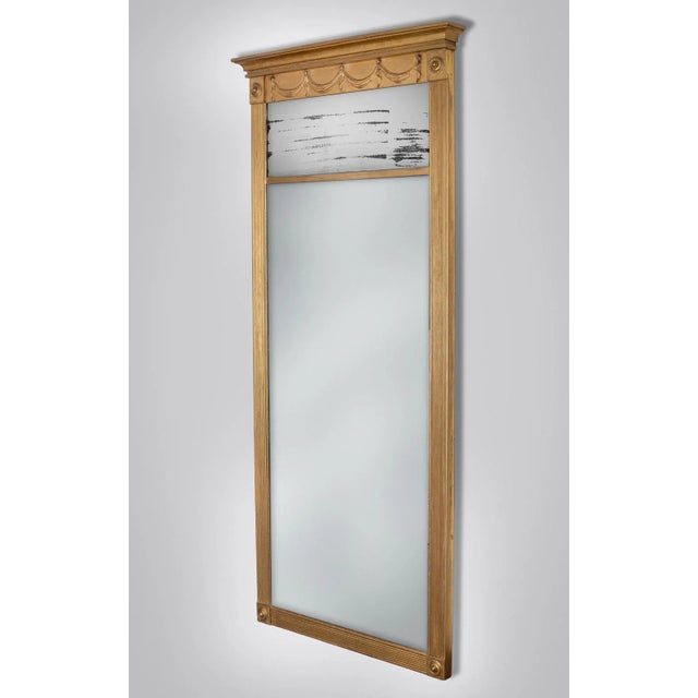American Federal gilded pier mirror with molded cornice set above a frieze of four carved swags, the two mercury glass...
