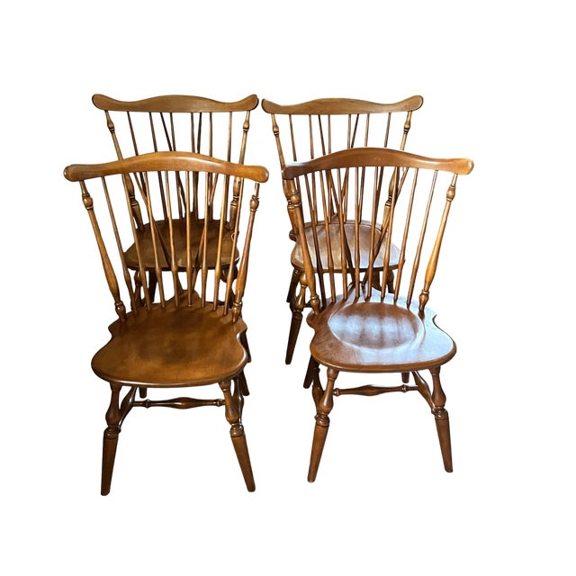 A beautifully collected set of four vintage Windsor dining chairs in a warm Nutmeg finish, consisting of two original...