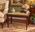 Charming vintage carved wood bench / accent table featuring an elegant floral needlepoint upholstered top and beautifully...