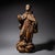 Carved and partially polychromed wooden sculpture of a Franciscan monk with raised arms and an upward gaze, likely...