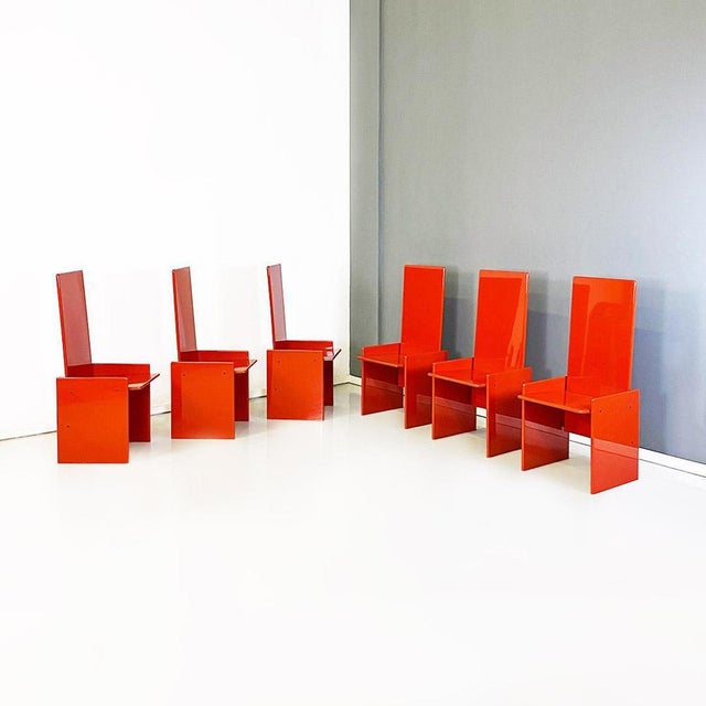 Set of four Kazuki model chairs with frame made entirely of orange-red lacquered wood, with geometric lines, glossy finish...
