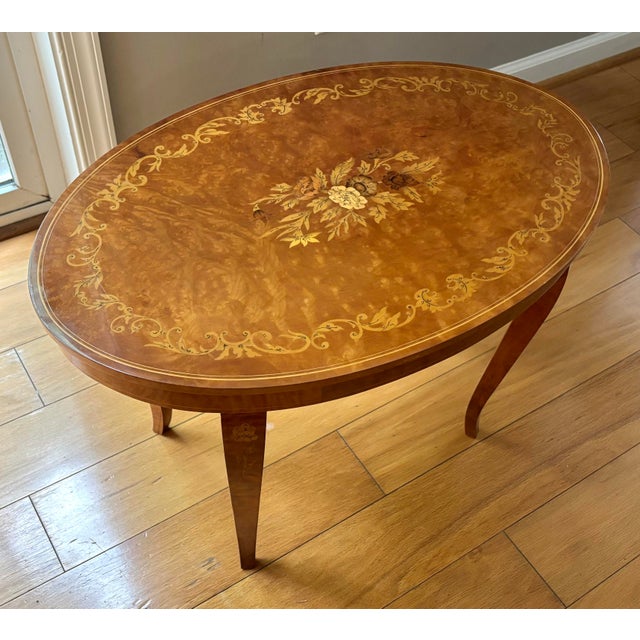 Stunning and petite Italian marquetry coffee table made with elegant burl wood and fine classical floral marquetry inlay....