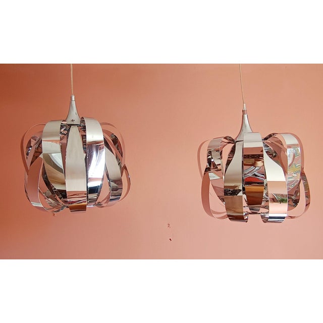 Pair of Seylumière pendant lights, space age style, circa 1990. Composed of thin steel blades, creating beautiful...
