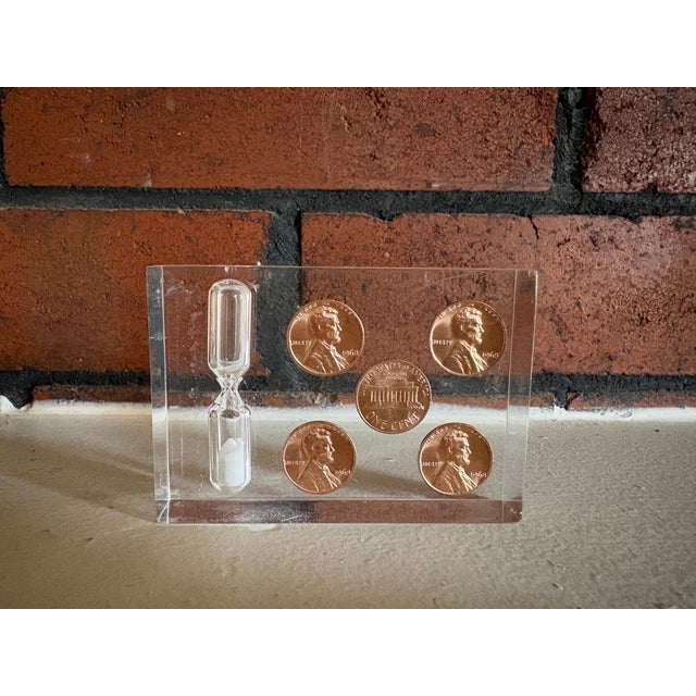 Quirky vintage desk accessory featuring five 1968 Lincoln pennies and a miniature glass hourglass encased in clear Lucite....