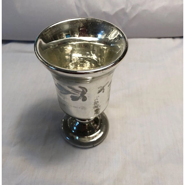 Mercury glass footed cup or small vase with raised white decoration.