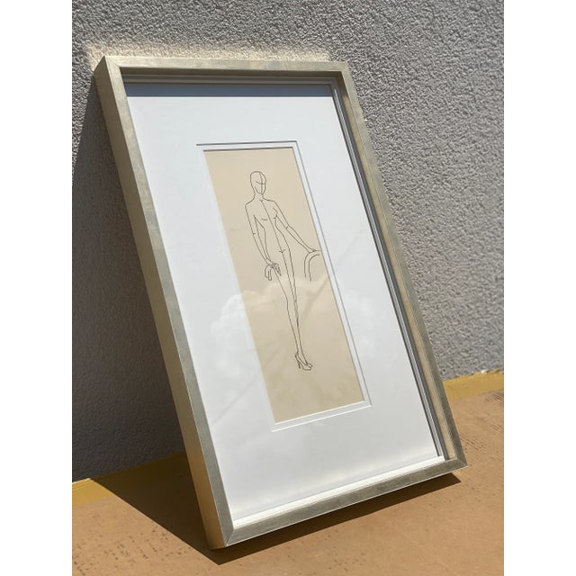This is a framed vintage fashion illustration. This particular piece features the original mannequin form drawn in ink....