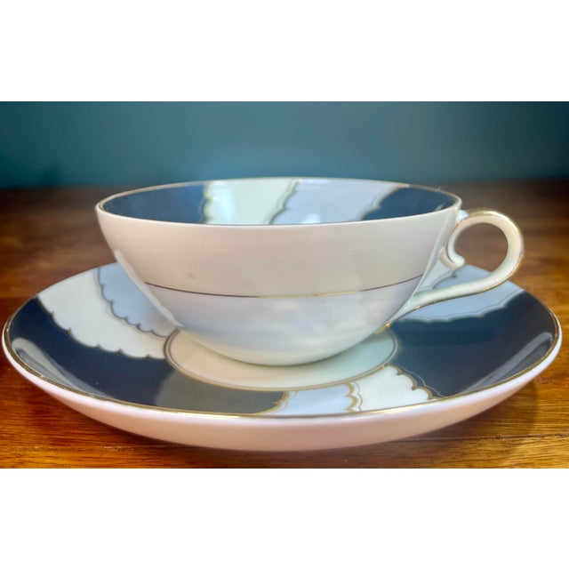 Art deco design in black, white, and blue gray pattern highlighted in gold. Cup- 4.75”L x 4”W x 1.75”H Saucer- 6”L