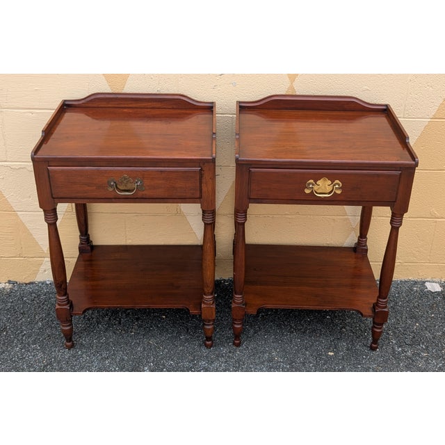 This exquisite pair of vintage Henkel Harris solid wild black cherry nightstands showcases the exceptional American...