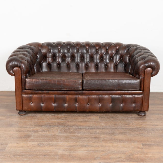 20th century Spanish brown leather Chesterfield 2- seat sofa or loveseat. Classic Chesterfield form with rolled arms,...