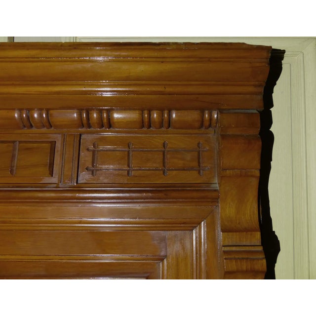 Antique late 19th century overmantel mirror having stained maple frame with paneled design and beveled glass mirror. The...