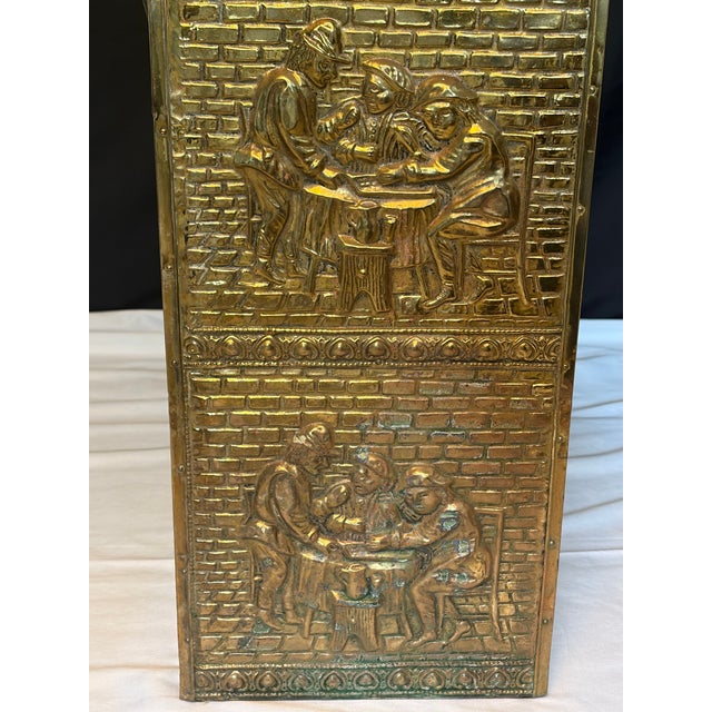 Antique English repoussé brass umbrella stand dating from the late 19th, featuring richly detailed figural relief panels...