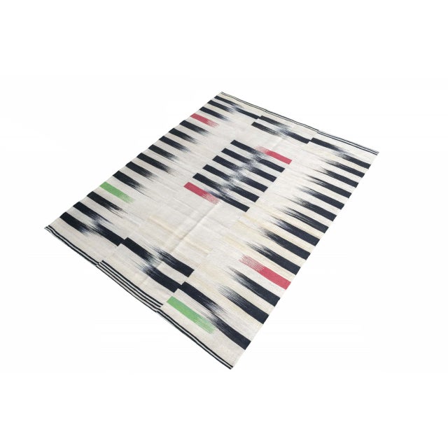 This exceptional handwoven designer kilim combines traditional weaving with modern design. The striking striped pattern in...