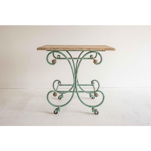 Late 19th c. French iron pastry or patisserie table, with original travertine top. The removable travertine top sits on a...