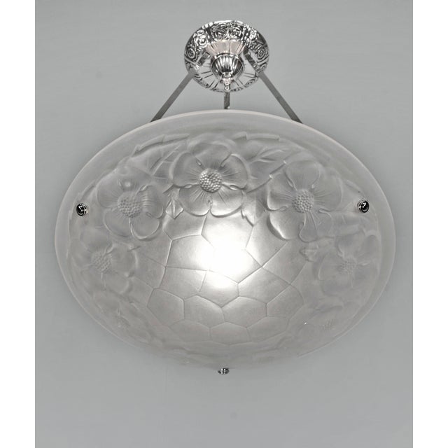 Degué A signed French art deco chandelier made around 1930 in nickel plated bronze or solid brass. The mounting holds a...