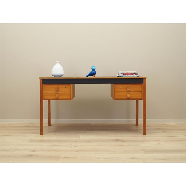 The desk was made in the 1970s, Danish production. The structure and the top of the furniture are covered with ash veneer....