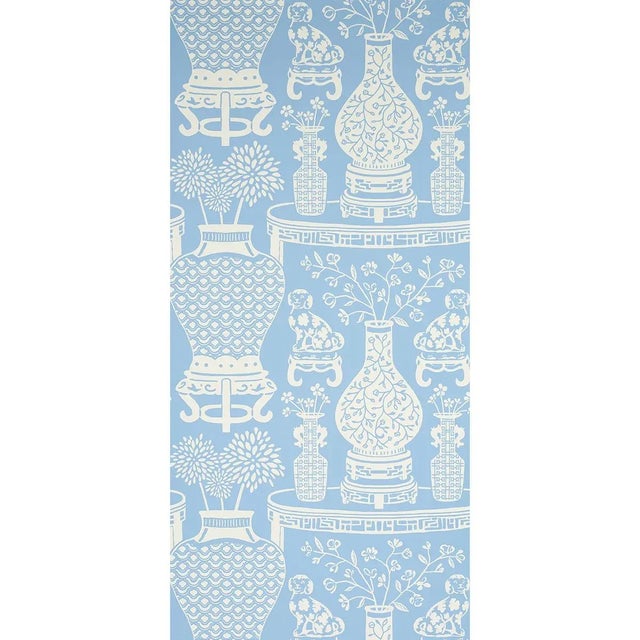 Hellene wallpaper features Ming vases and Staffordshire dogs in a pattern-on-pattern extravaganza with a mirrored repeat....