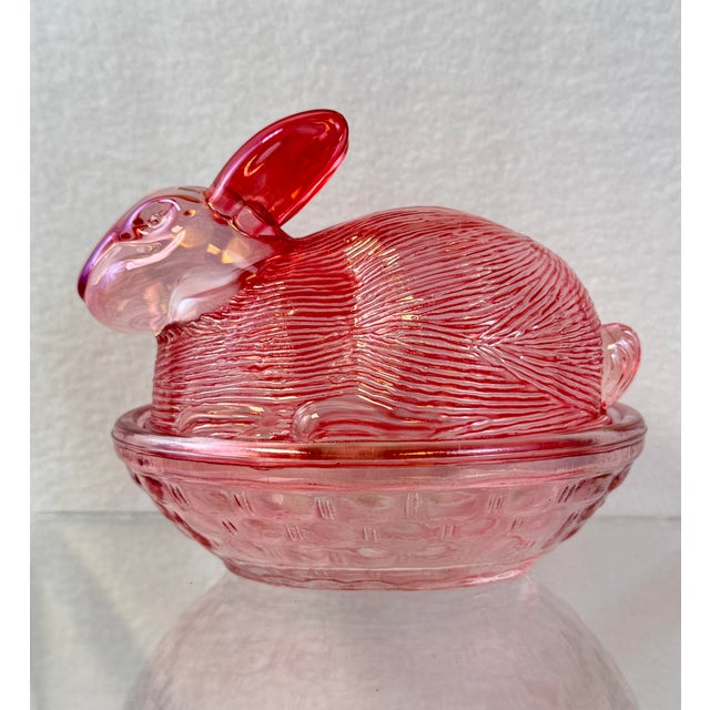 Cranberry pink, shiny nesting bunny. No chips or cracks noted. Stands 4” tall x 4.5” x 3.25”.