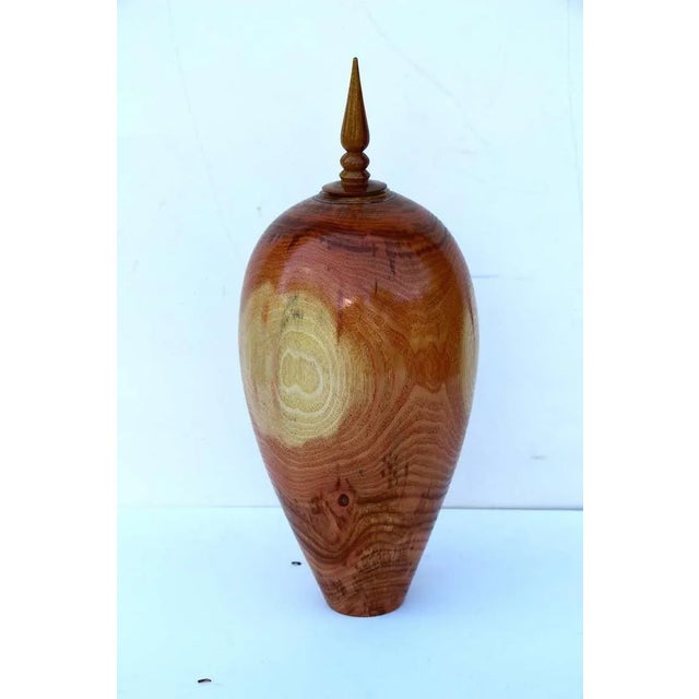 A simply stunning hand-turned vase by the noted Florida wood turner John Mascoll out of honey locust. The top finial is...