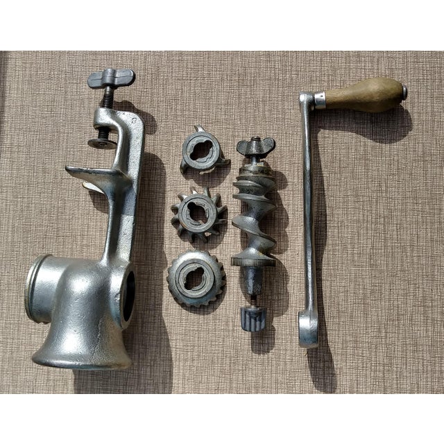 Universal #2 heavy metal hand meat grinder with 3 different-sized grind attachments. Wood-handled crank. 4” w x 10 1/4” h...
