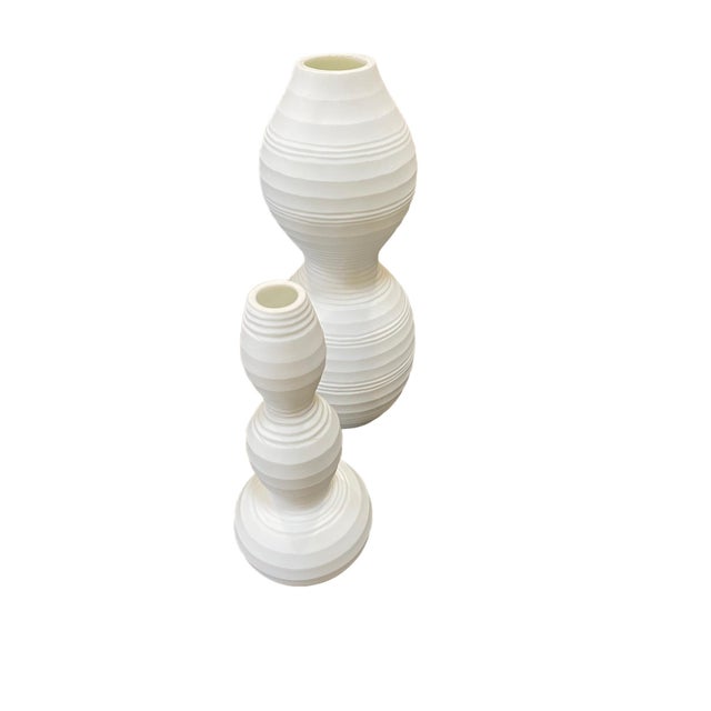 Set of Two White Vases have an abstract, sculptural quality, with soft, organce curves that give them a modern yet...