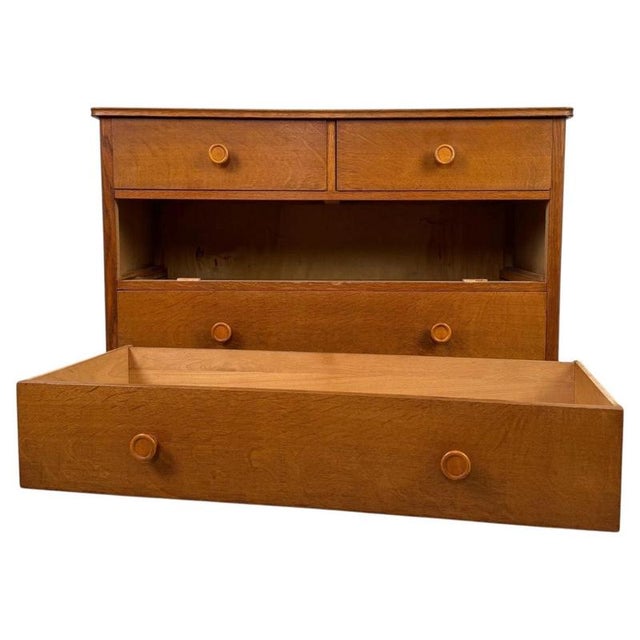 A handsome vintage 20th-century Dutch chest of drawers, finely constructed from oak and distinguished by its warm golden...